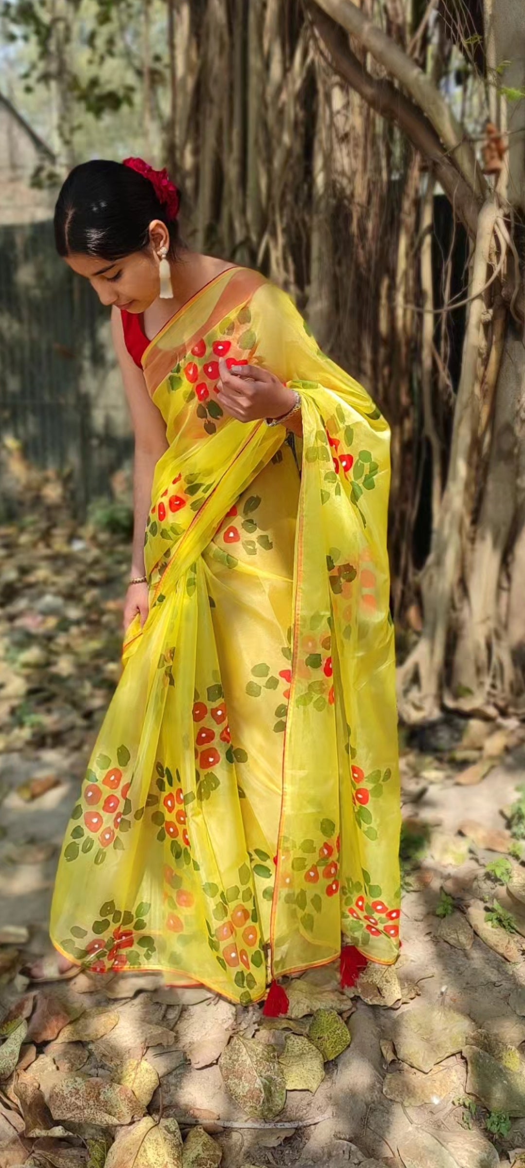 Yellow Hand-painted organza saree with beautiful Red tassels