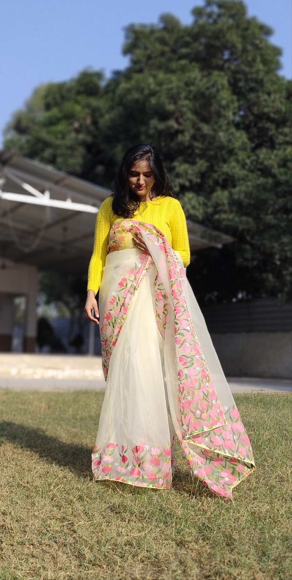 Hand painted pastel yellow saree with pink flowers.