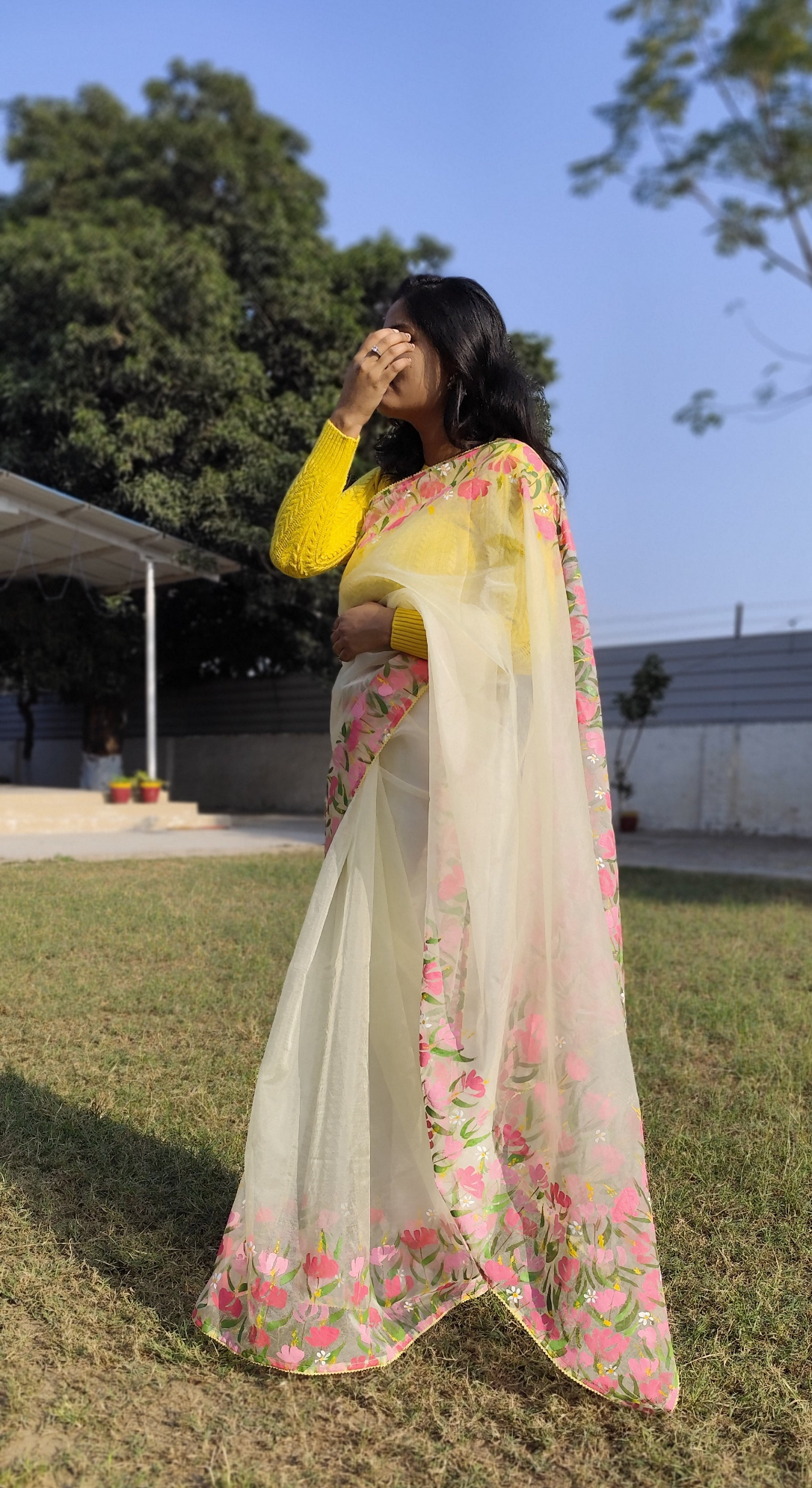 Hand painted pastel yellow saree with pink flowers.