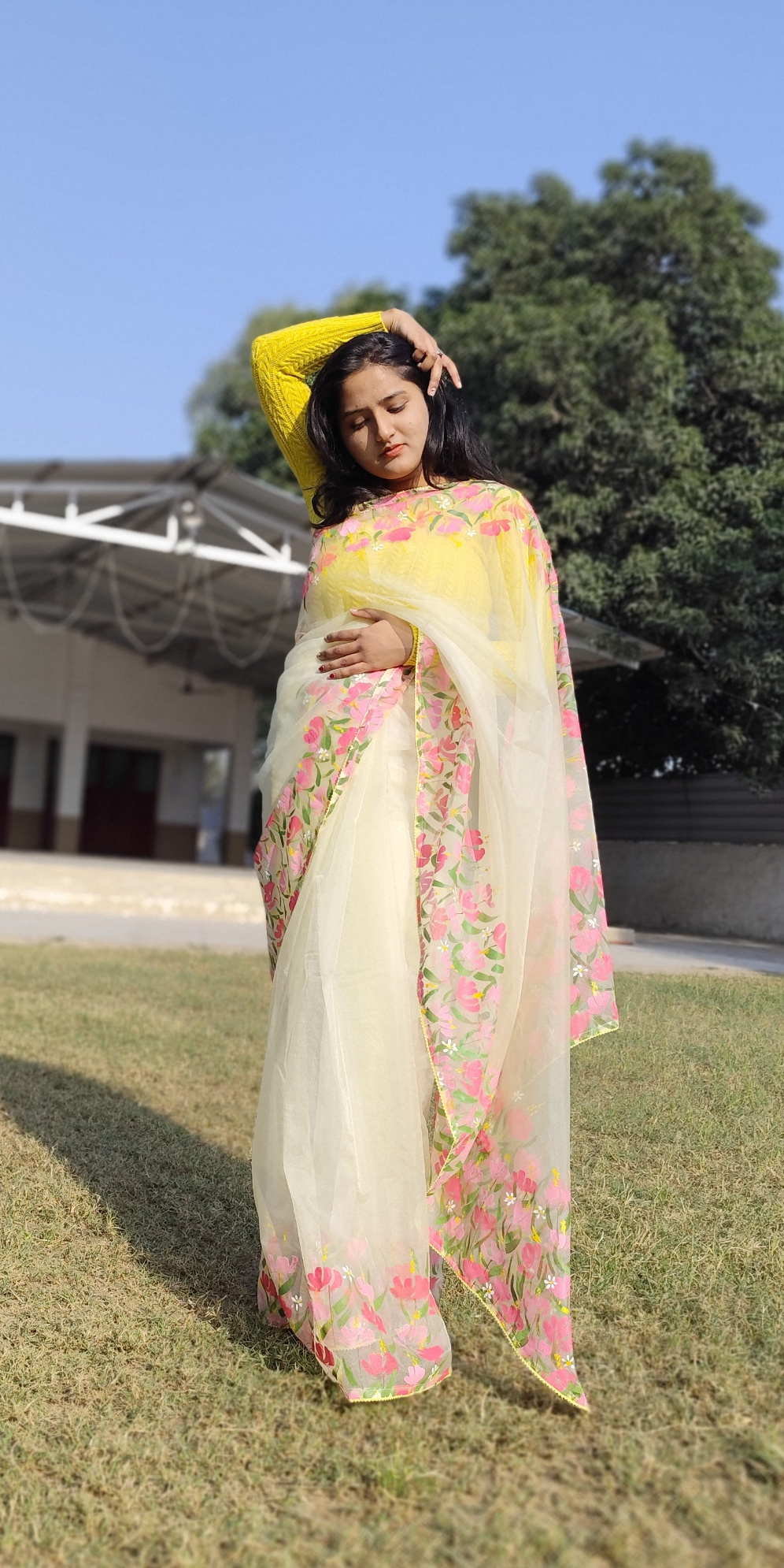 Hand painted pastel yellow saree with pink flowers.
