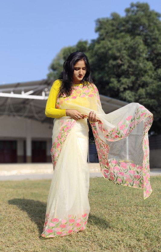 Hand painted pastel yellow saree with pink flowers.