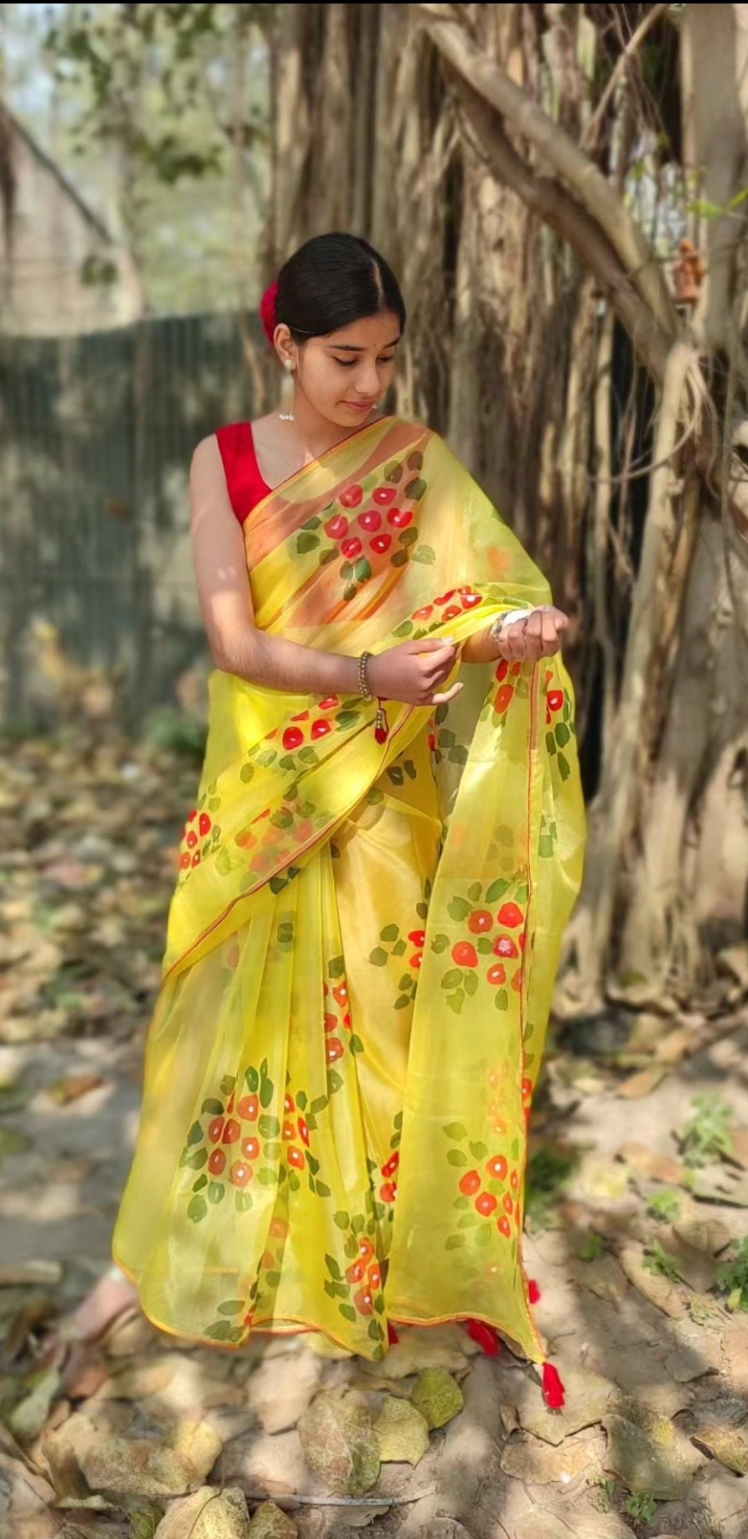 Yellow Hand-painted  organza saree with  beautiful Red tassels