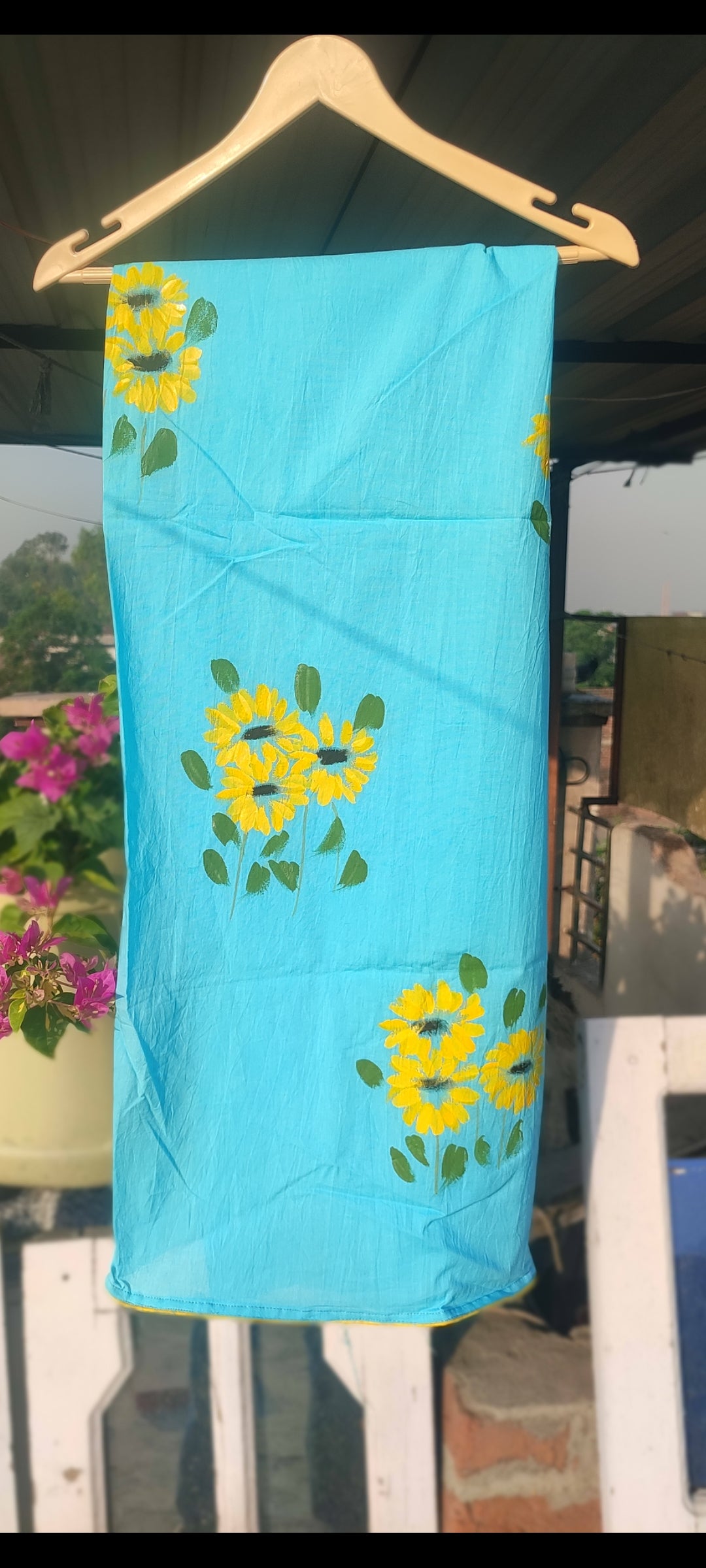 Hand painted  sky blue suit with beautiful sunflowers and organza dupatta.