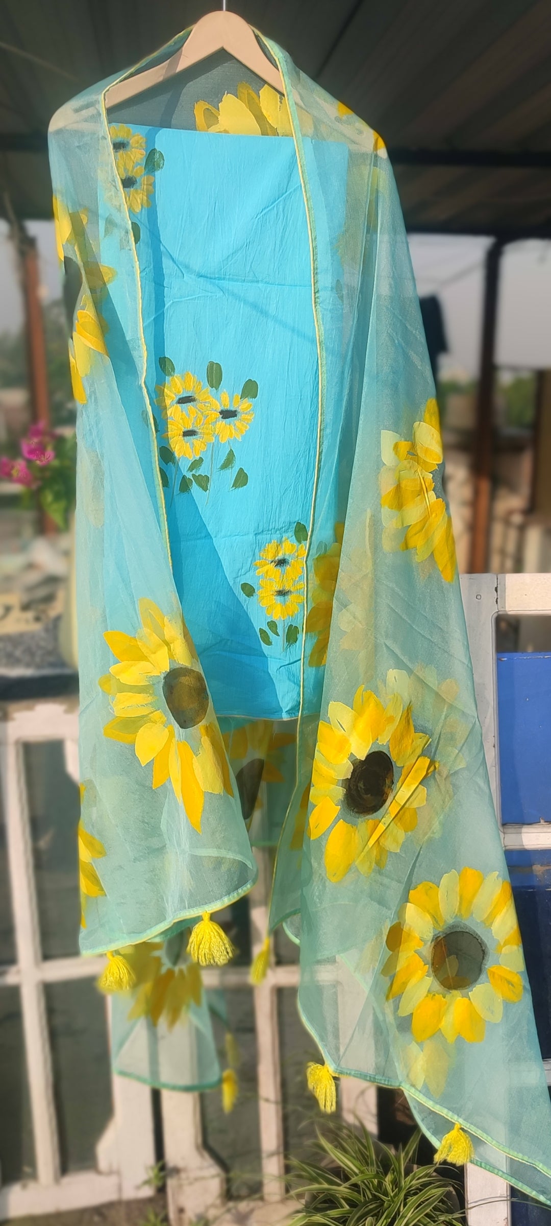 Hand painted  sky blue suit with beautiful sunflowers and organza dupatta.