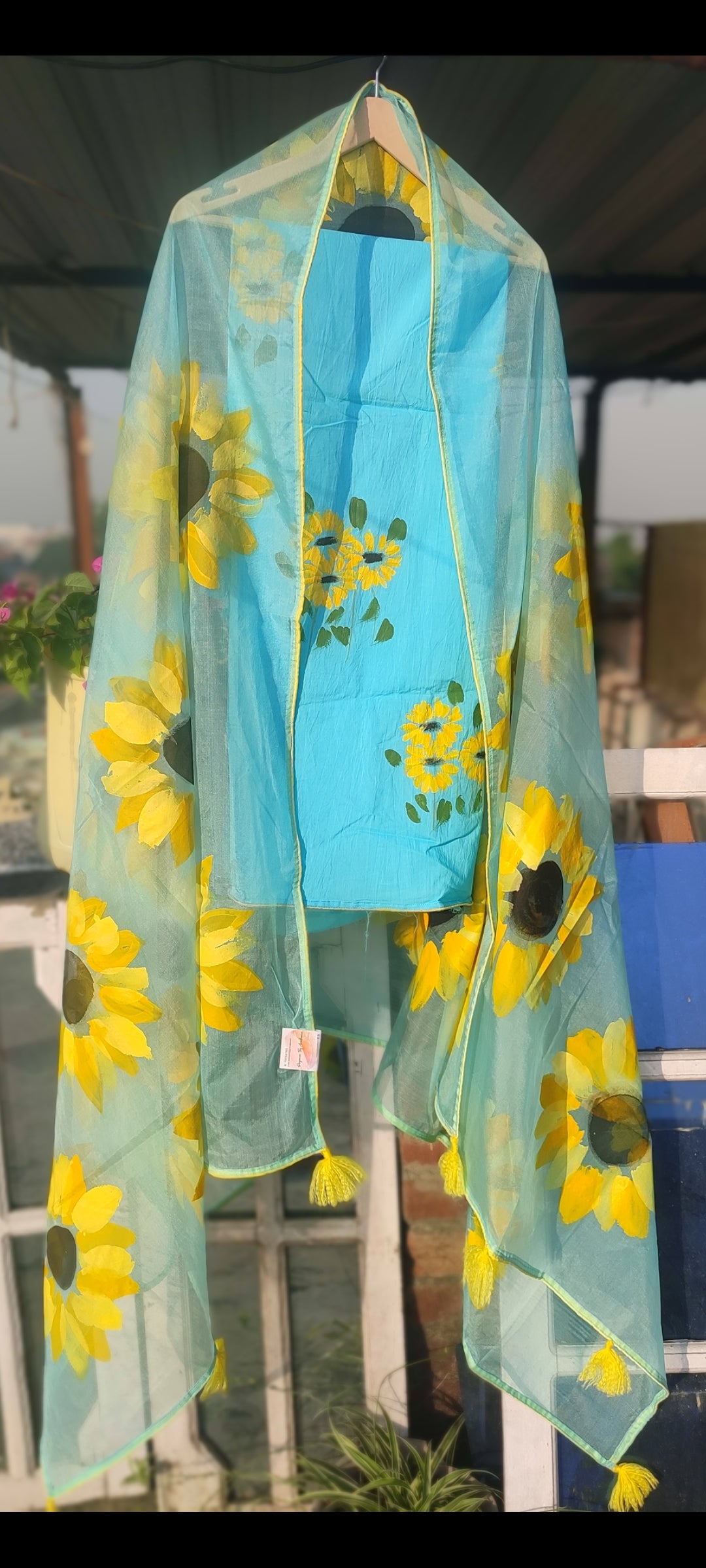 Hand painted  sky blue suit with beautiful sunflowers and organza dupatta.