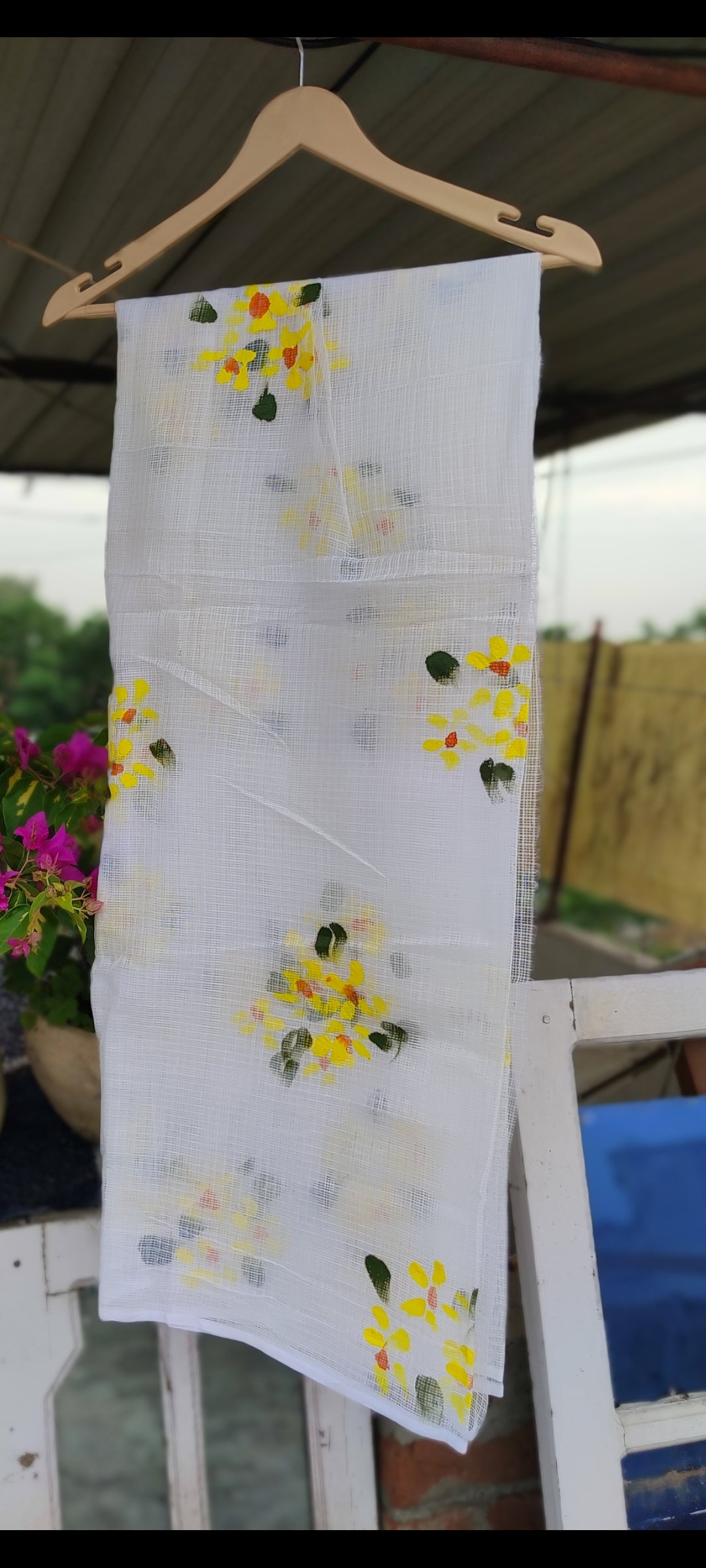 Hand-painted white pure kota doria suit with yellow flowers.