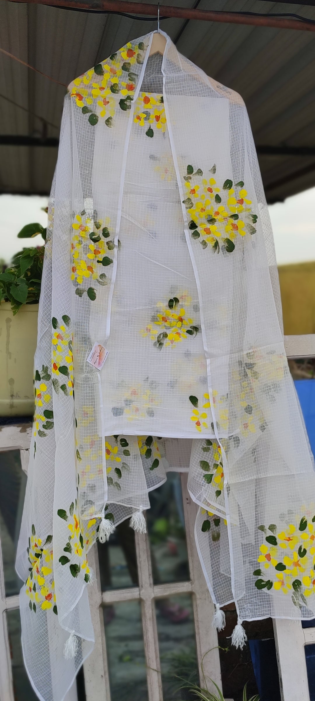 Hand-painted white pure kota doria suit with yellow flowers.