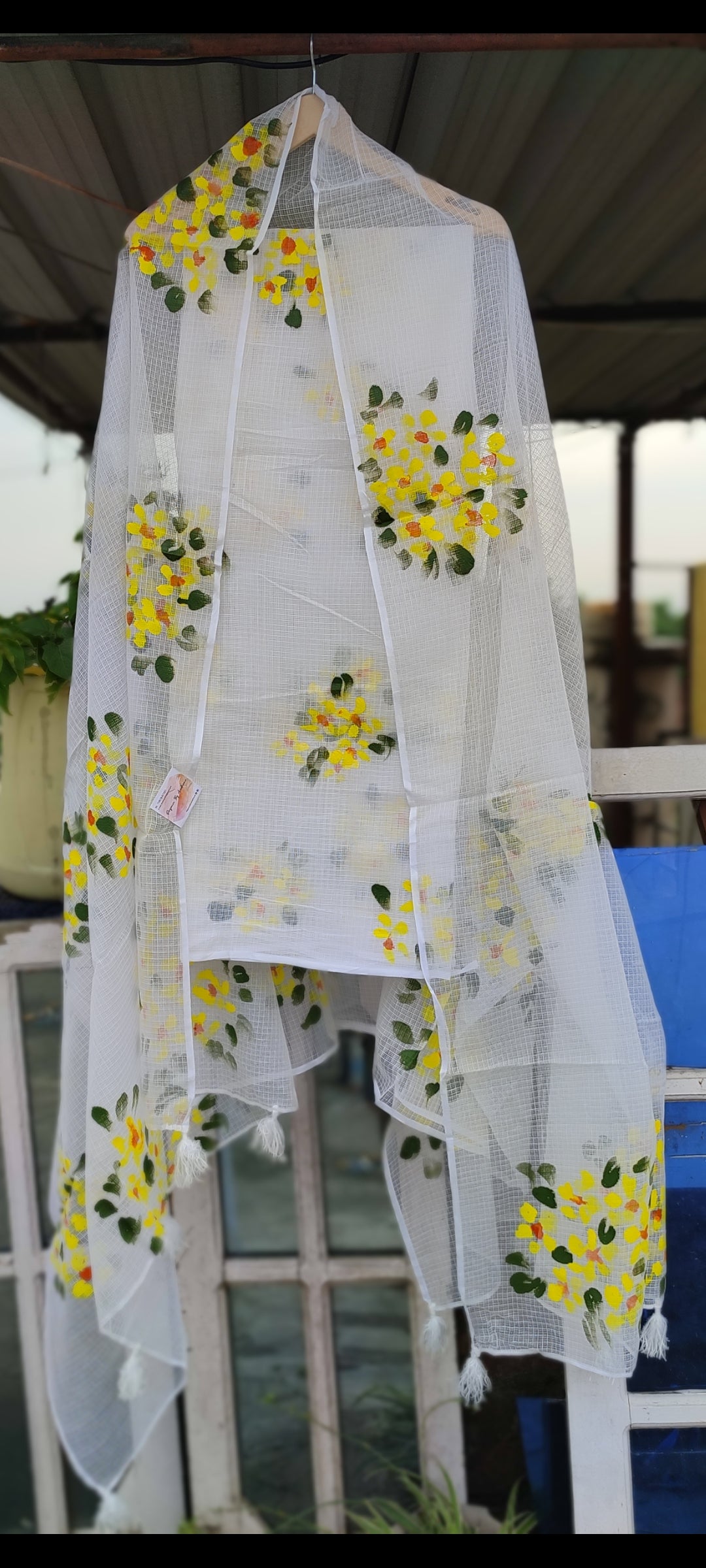 Hand-painted white pure kota doria suit with yellow flowers.