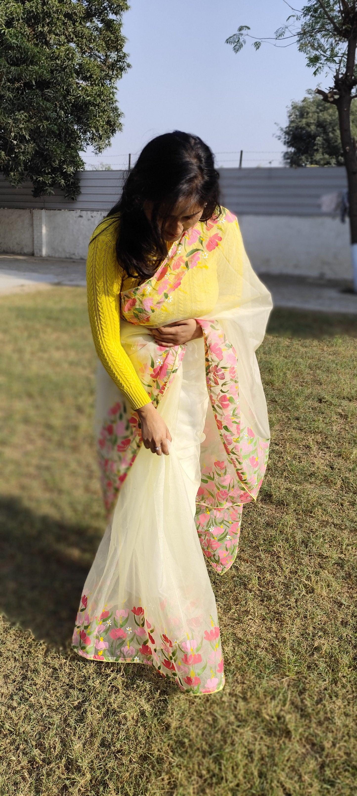 Hand painted pastel yellow saree with pink flowers.